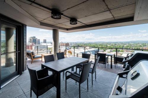 a patio with a table and chairs on a balcony at 1CH - Rooftop pool - Kitchen - Smart TV - Gym - 750m QC in Quebec City