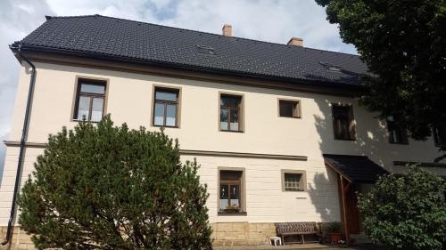 a white house with a black roof at Ubytování Ždírec - Apartmán 2 in Ždírec