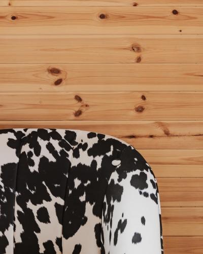 a black and white cow print shirt on a wooden wall at The Tree Houses at Madeira in Fife in Pittenweem