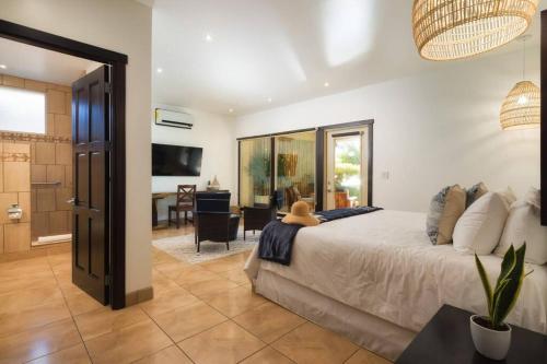 a bedroom with a large bed and a living room at Villa Oceano in Potrero