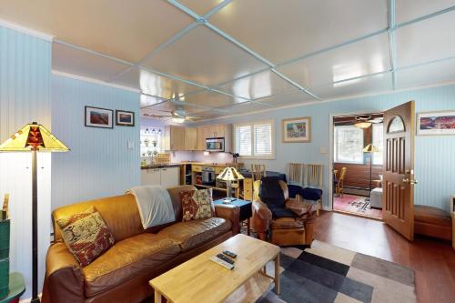 a living room with a couch and a table at Kachina Village in Mountainaire
