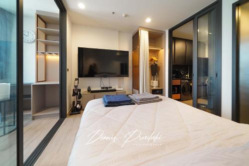 a bedroom with a large bed and a tv at Edge Central Pattaya Seaview in Pattaya South