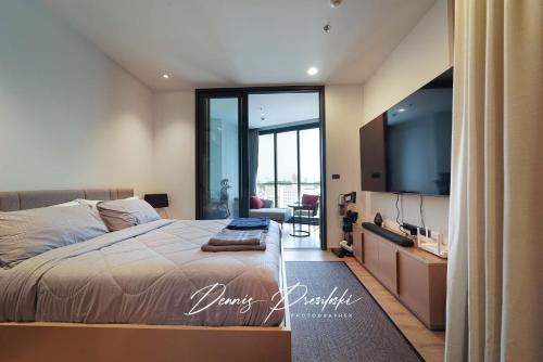 a bedroom with a large bed and a flat screen tv at Edge Central Pattaya Seaview in Pattaya South
