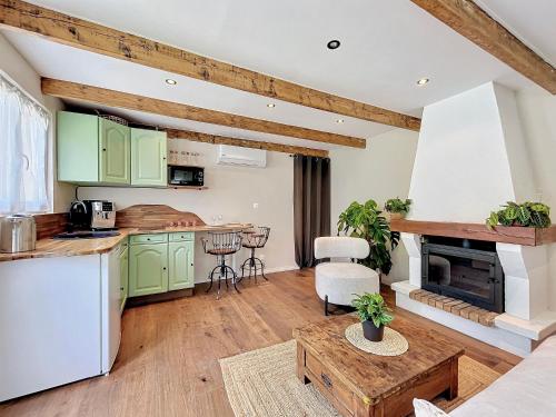 a kitchen with green cabinets and a table at Maison avec jacuzzi et terrasse in Pontault-Combault