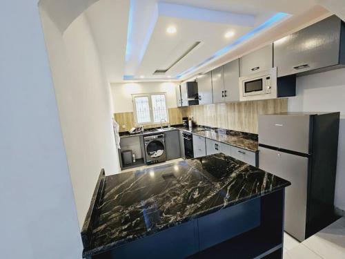 a kitchen with a black counter top in a room at Holiday Residence at Sea Side in Limbe in Limbe