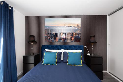 a bedroom with a blue bed with two blue pillows at The East Retreat in Manchester
