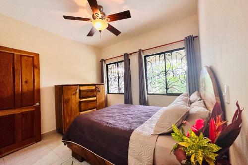 a bedroom with a bed and a ceiling fan at Villa Camino Corral By Vacation Pura Vida in Esterillos