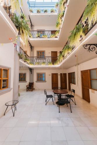 an empty room with tables and chairs in a building at Hotel Marques Del Valle in Oaxaca City