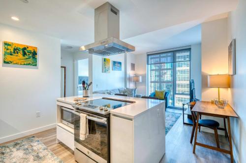 a kitchen with a stove top oven next to a table at Luxury Apt with City Views in Boston