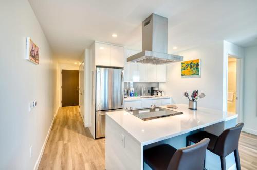 a kitchen with white cabinets and a counter top at Luxury Apt with City Views in Boston