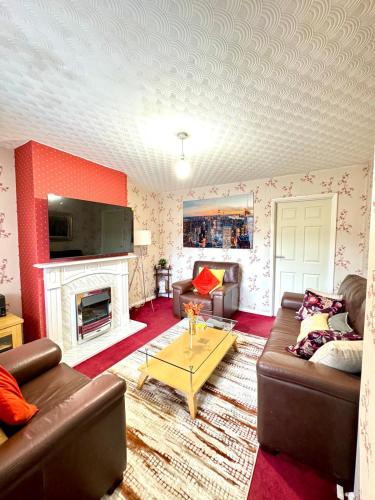 a living room with a couch and a fireplace at Cosy Inn near Luton Station, Mall and Luton Airport 10 Min in Luton