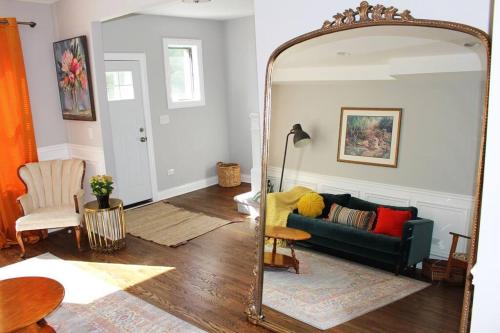 a living room with a mirror and a couch at BOUTIQUE GARDEN HOUSE CHICAGO 3-STORY sleeps 12 in Chicago
