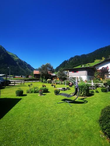 a green park with a statue in the grass at Landhaus Thaler in Mittelberg