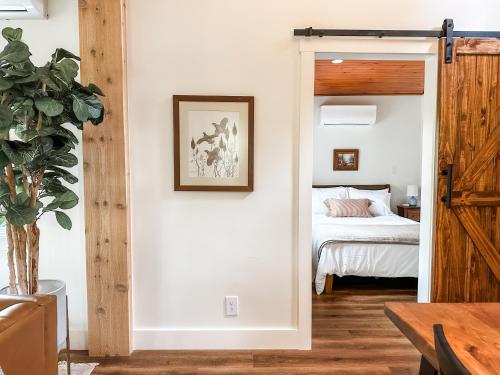 a room with a bed and a door leading to a bedroom at Lakeside Cabin - Serene Retreat with Lake Monroe Views and Wraparound Deck in Brown County in Nashville