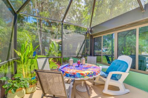 a screened in porch with a table and chairs at Canal-Front Outdoor Oasis Home in Crystal Water in Crystal River