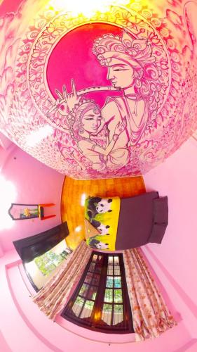 a plate with a picture of a woman holding a baby at Santa Maria Hostel Kovalam in Kovalam