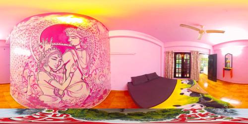 a room with a large vase with paintings on it at Santa Maria Hostel Kovalam in Kovalam