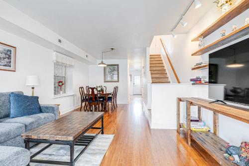 a living room with a couch and a table at Peaceful & spacious family home near Carytown fully fenced in Richmond