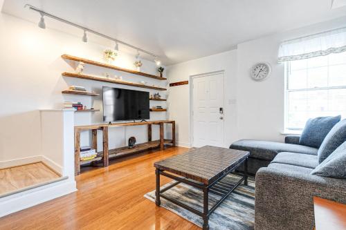 a living room with a couch and a tv at Peaceful & spacious family home near Carytown fully fenced in Richmond