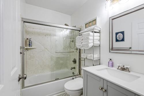 a bathroom with a shower and a toilet and a sink at Peaceful & spacious family home near Carytown fully fenced in Richmond