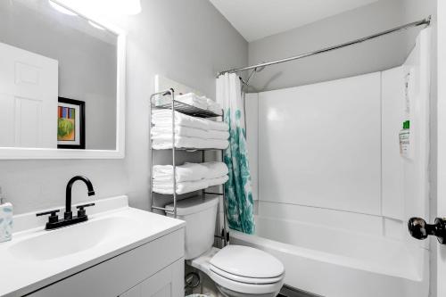 a bathroom with a sink and a toilet and a shower at Grand Carytown family home 6BR FREE parking in Richmond