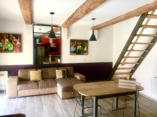 a living room with a couch and a table at L'atelier in Capestang