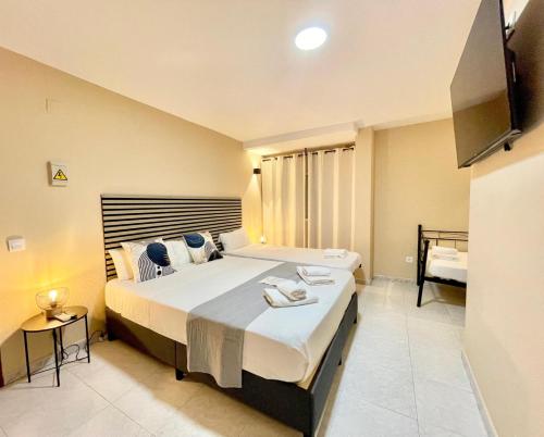 Ένα ή περισσότερα κρεβάτια σε δωμάτιο στο Júbilus Rooms
