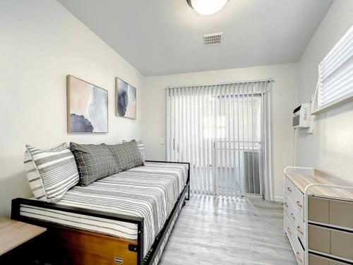 a living room with a bed and a window at Family-friendly 2br Wi-fi Pets Near Disney in Orlando