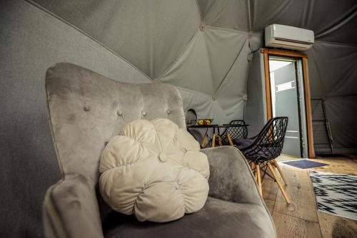 a chair sitting in a room with a tent at Glamping nad Sanem in Krzemienna