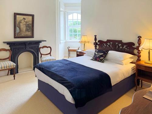 a bedroom with a large bed and a fireplace at Stella Maris Shore House in Ballycastle
