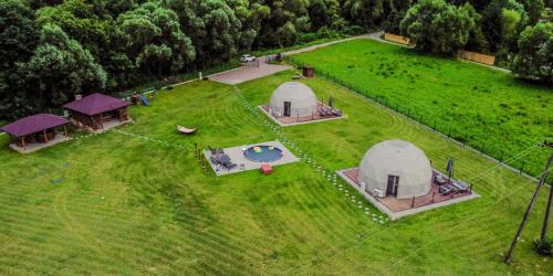 an aerial view of three tents on a field at Glamping nad Sanem in Krzemienna