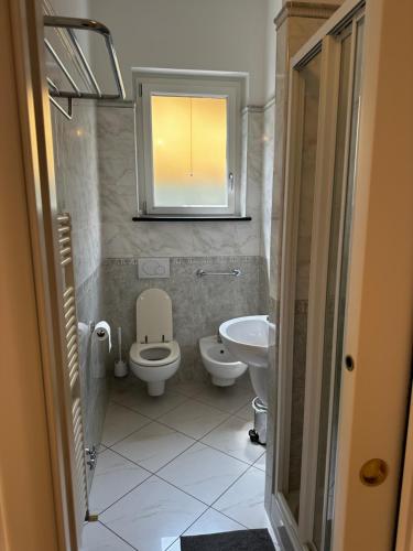 a bathroom with a toilet and a sink and a mirror at Camere Margot in Monterosso al Mare