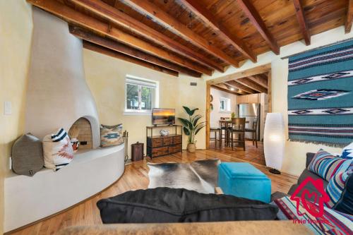 a living room with a couch and a fireplace at Charming Adobe Revival- An Irvie Home in Santa Fe