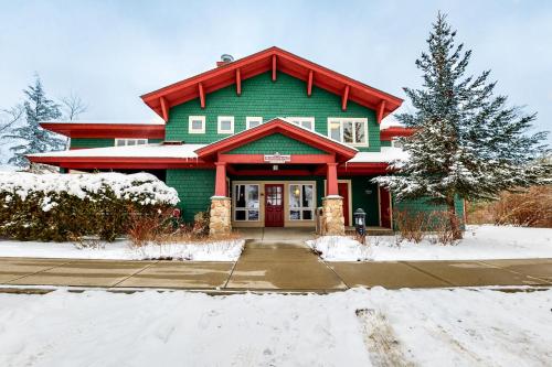 a green house with a red roof in the snow at Eagles Unit #1 in Jeffersonville