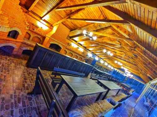 an overhead view of a picnic table in a building at Pensiunea Pastravaria Vistisoara in Vistisoara