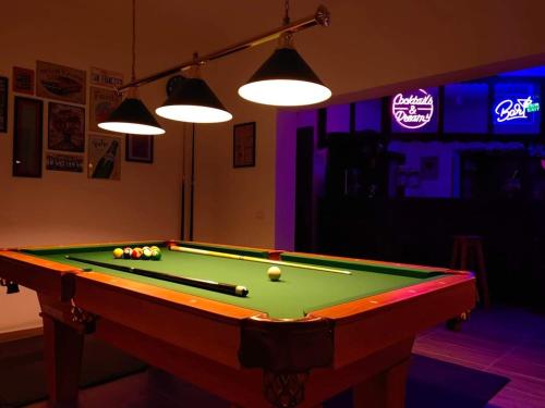 a pool table with balls on it in a room at Pensiunea Pastravaria Vistisoara in Vistisoara