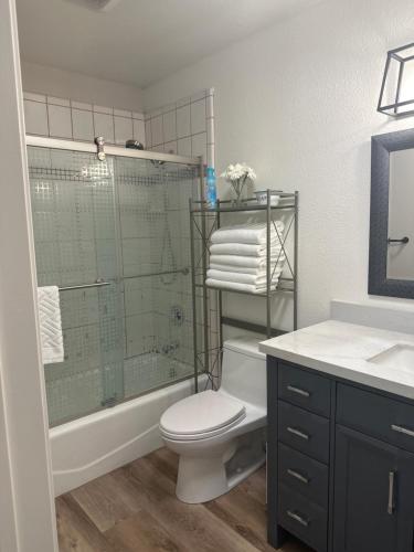 a bathroom with a shower and a toilet and a sink at YoBee! Park Reservation Included! Heart of Yosemite - Homey Studios and Breakfast in Yosemite West