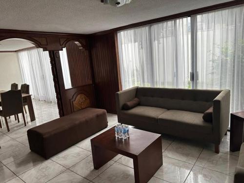 a living room with a couch and a table at Hermosa casa grande en San Manuel in El Gallinero