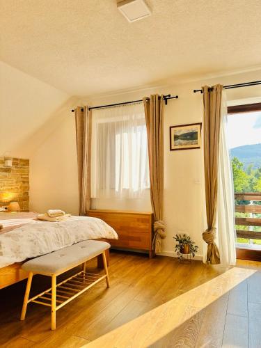 a bedroom with a bed and a large window at B&B Villa Plitvica in Plitvica Selo