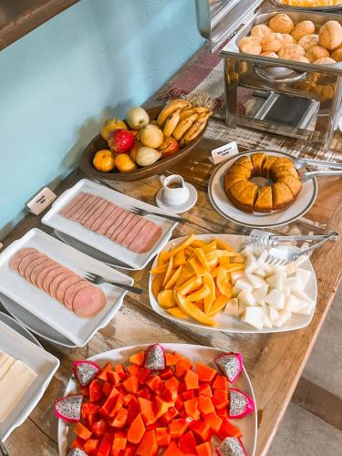 Una mesa cubierta con muchos tipos diferentes de comida en Pousada Vila Tamarindo Eco Lodge, en Florianópolis