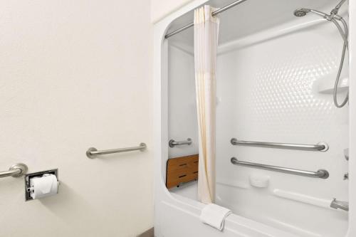 a bathroom with a shower with a mirror at Best Western StateLine Lodge in West Siloam Springs