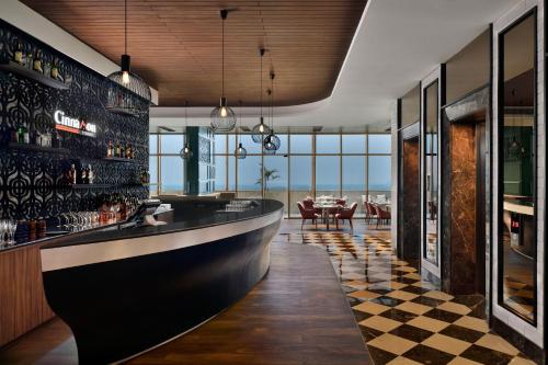 a bar with a black and white checkered floor at Courtyard by Marriott Siliguri in Siliguri