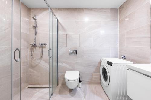 a bathroom with a shower and a toilet and a sink at Matilda108 in Prague