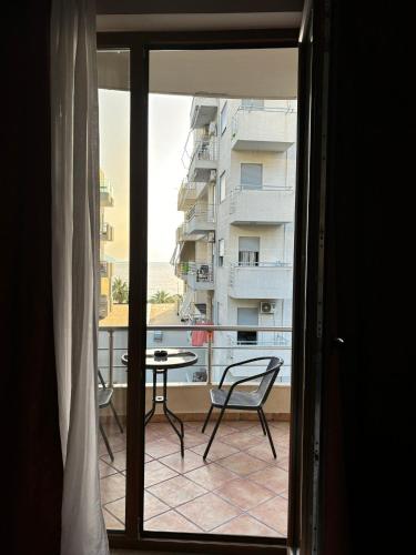 a view of a balcony with a table and a building at Hotel Vlora 78 in Vlorë