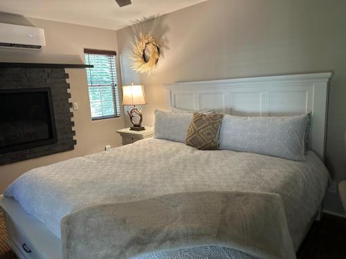 a bedroom with a large bed and a fireplace at YoBee! Park Reservation Included! Heart of Yosemite - Homey Studios and Breakfast in Yosemite West