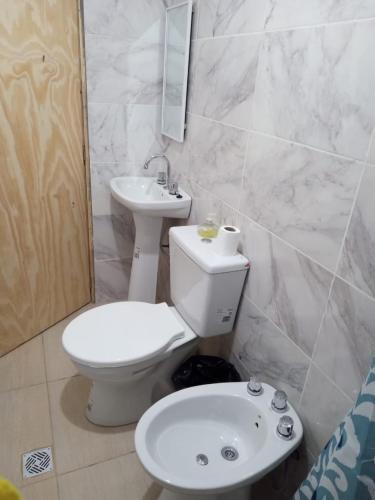 a bathroom with a toilet and a sink at FORTIN HOUSE in Malargüe