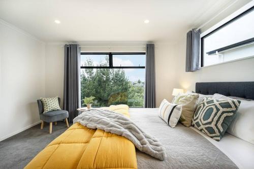 a bedroom with a large bed with a yellow blanket at Riverview Retreat-4 bedrooms Brand New House In Hamilton in Hamilton