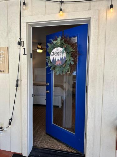 a blue door with a wreath on it at YoBee! Park Reservation Included! Heart of Yosemite - Homey Studios and Breakfast in Yosemite West