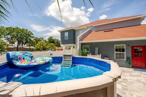 a pool with a chair and a house at 4 Bedroom 3 Full Bath Boho Oasis Saltwater Pool Near Downtown, North of Hyde Park Sleeps 12 Pets OK in Tampa