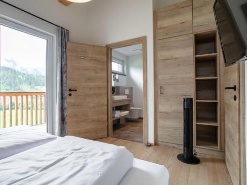 a bedroom with a bed and a large window at Apart33 Top 2-12A in Haus im Ennstal